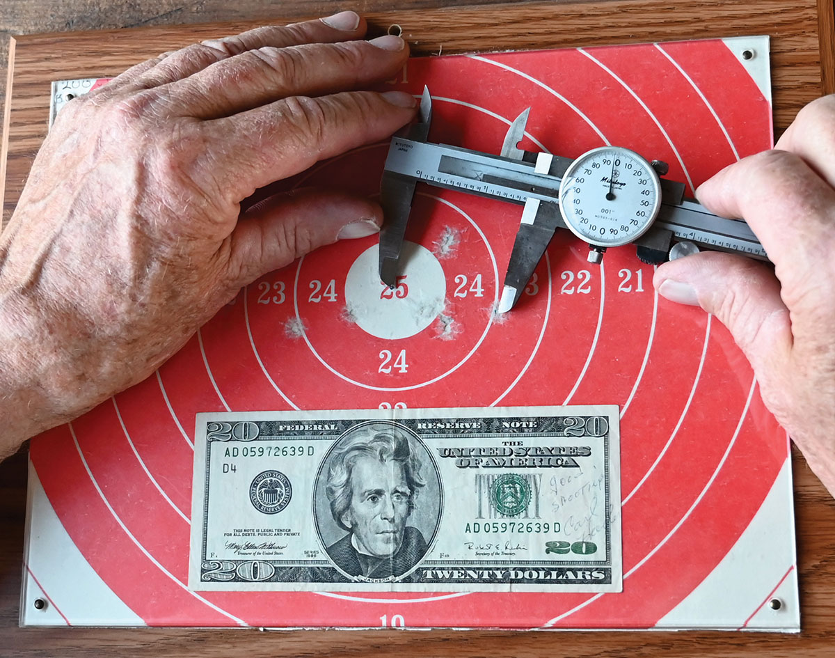 Using a dial caliper to determine the aggregate string measure.